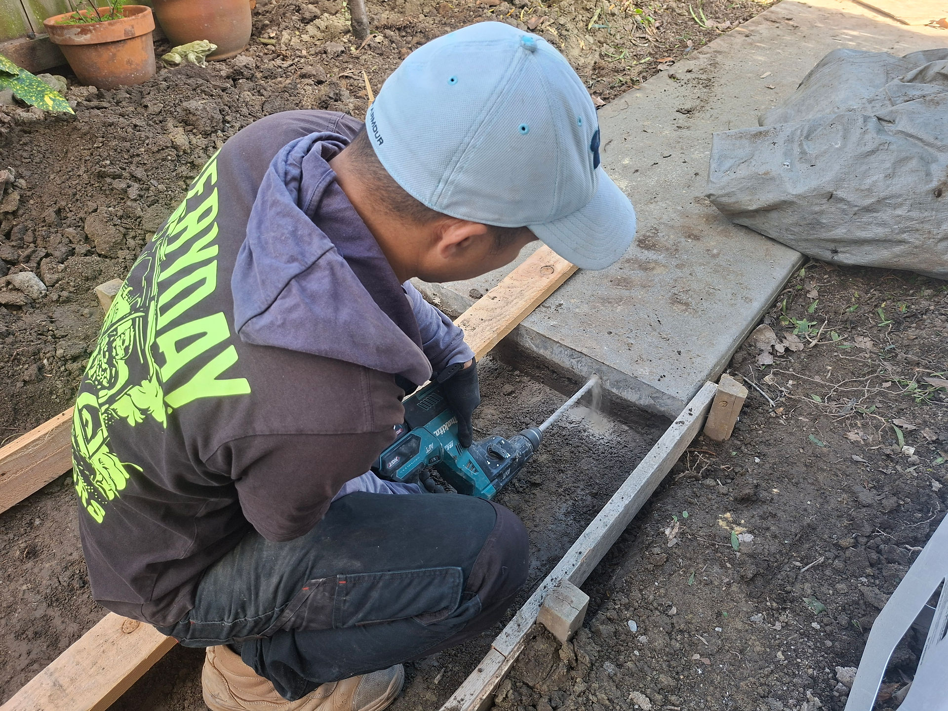Installing starter rods to connect new and existing concrete sections during a residential footpath 