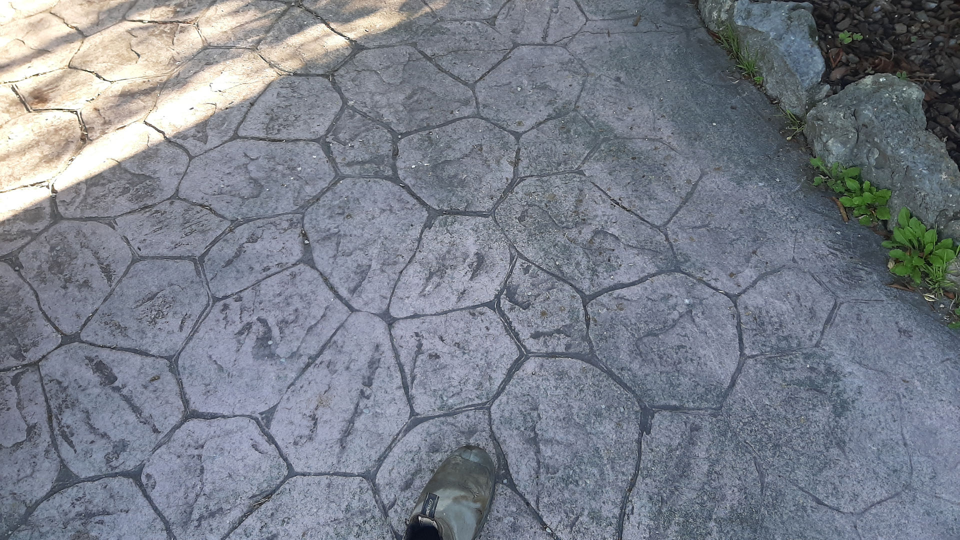 Original stamped concrete driveway surface before widening and concrete matching project completed i