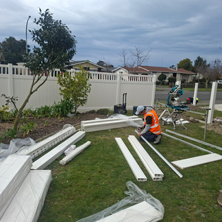Builder assembling PVC fence