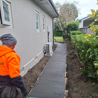 Freshly placed concrete footpath after initial finishing and levelling during construction in Hawke'