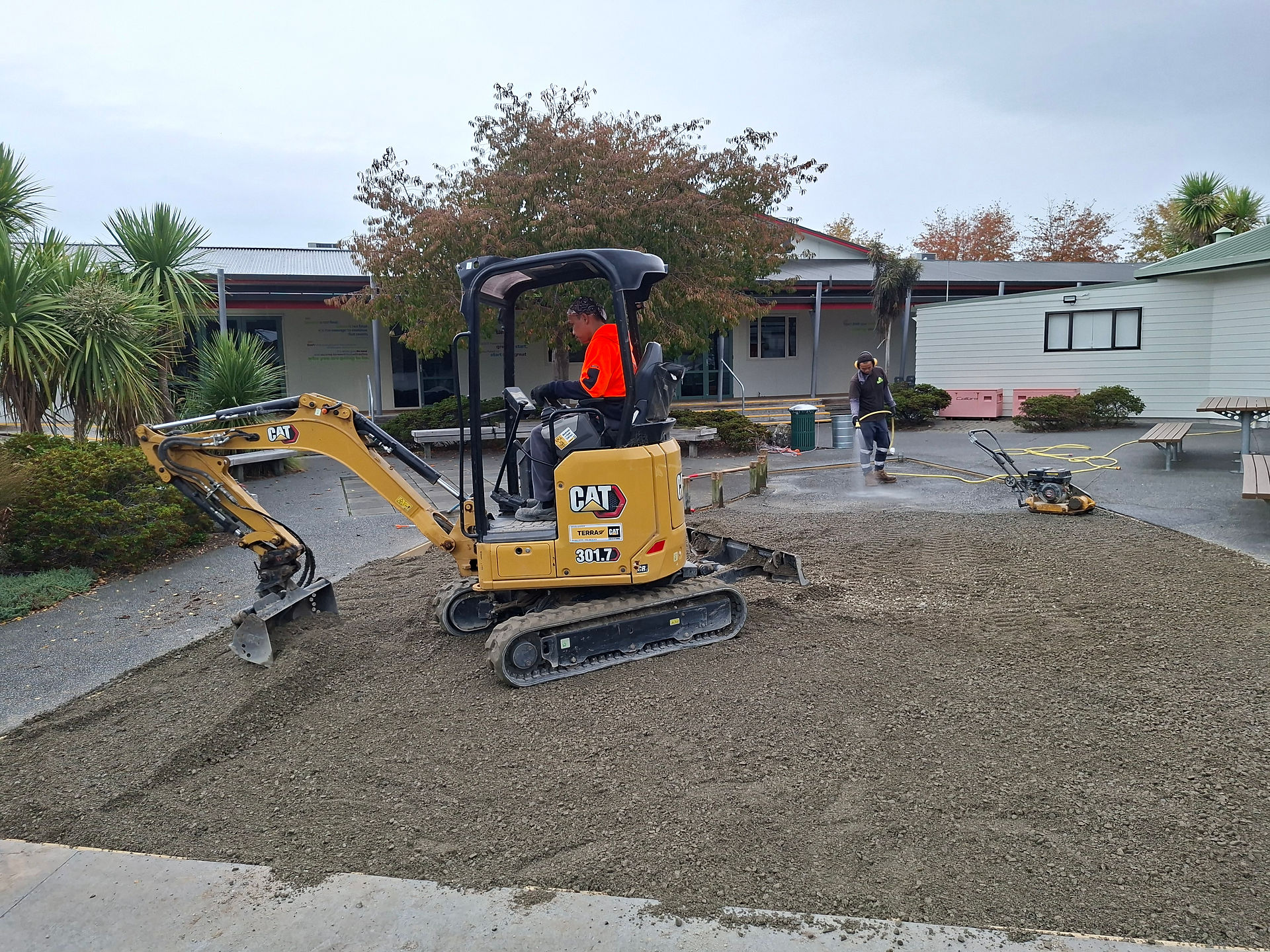 Excavator working on artificial turf installation site in Hastings