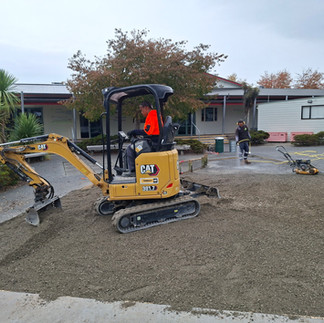 Excavator working on artificial turf installation site in Hastings