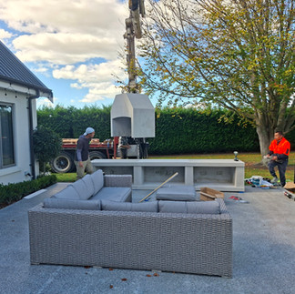 Wide view of Flare outdoor fireplaces installation with seating area and crane in Hastings
