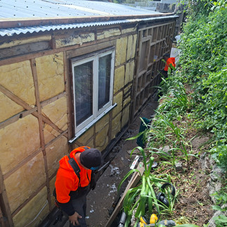 House wall upgraded with modern insulation and weatherproof building wrap before recladding and exte