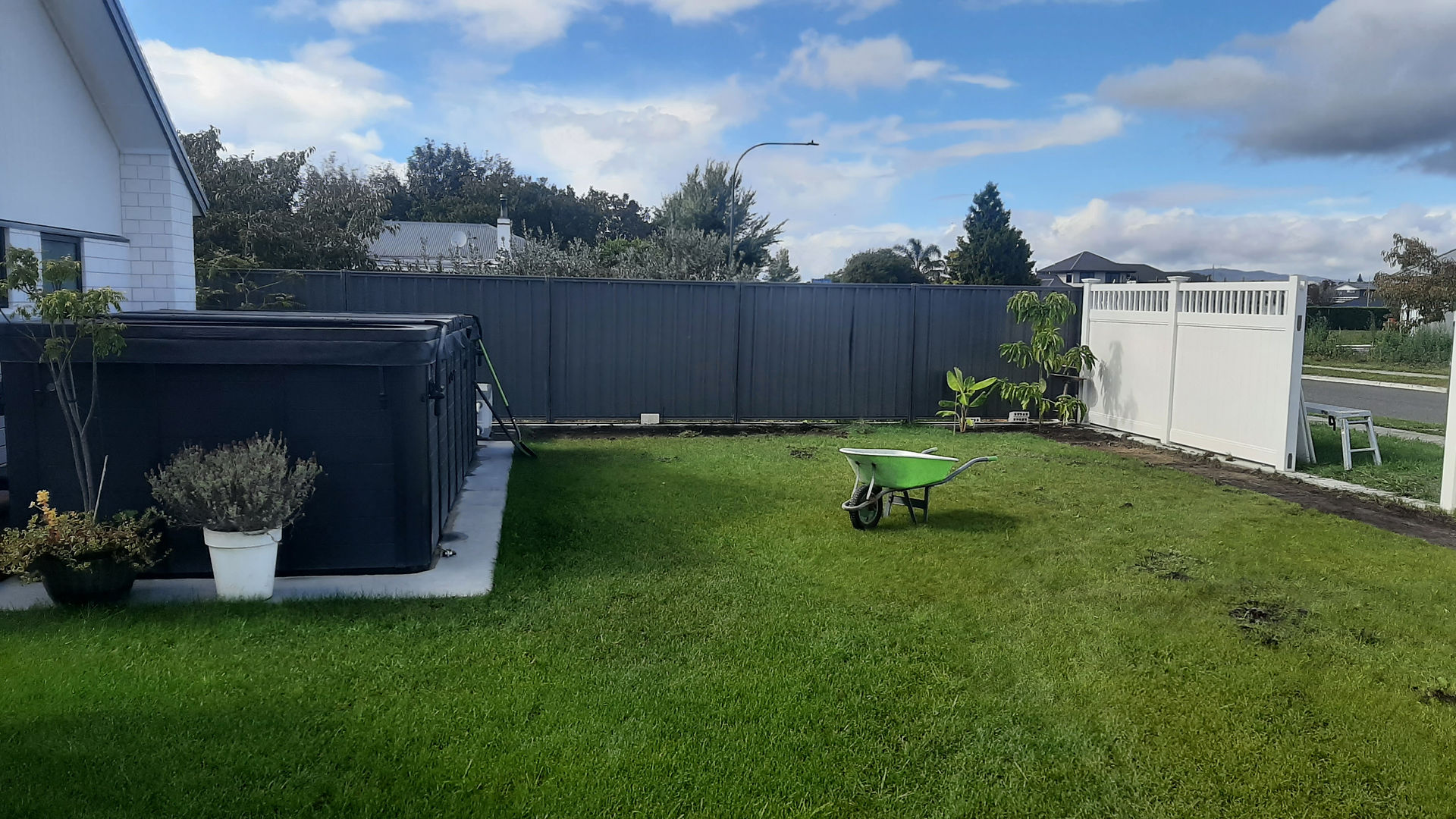 Backyard enclosed with PVC fencing and neighbouring boundary fence in Hastings