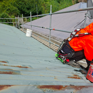 Making repairs to the roof before painting