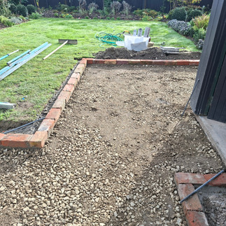 Prepared patio area framed with reclaimed brick edging and compacted basecourse ready for concrete i