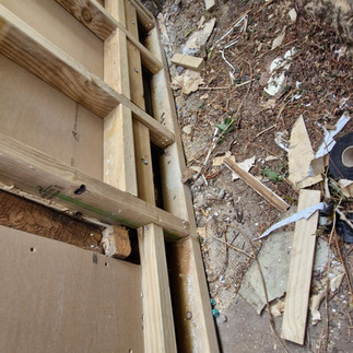 Rebuilding exterior wall framing and replacing damaged timber as part of a complete house recladding