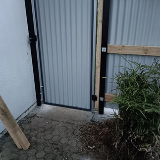 New Smart Coloursteel pedestrian gate providing secure access alongside the completed boundary fence