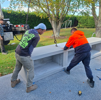 Contractors guiding fireplace base section into place using HIAB for Flare outdoor fireplaces in Has