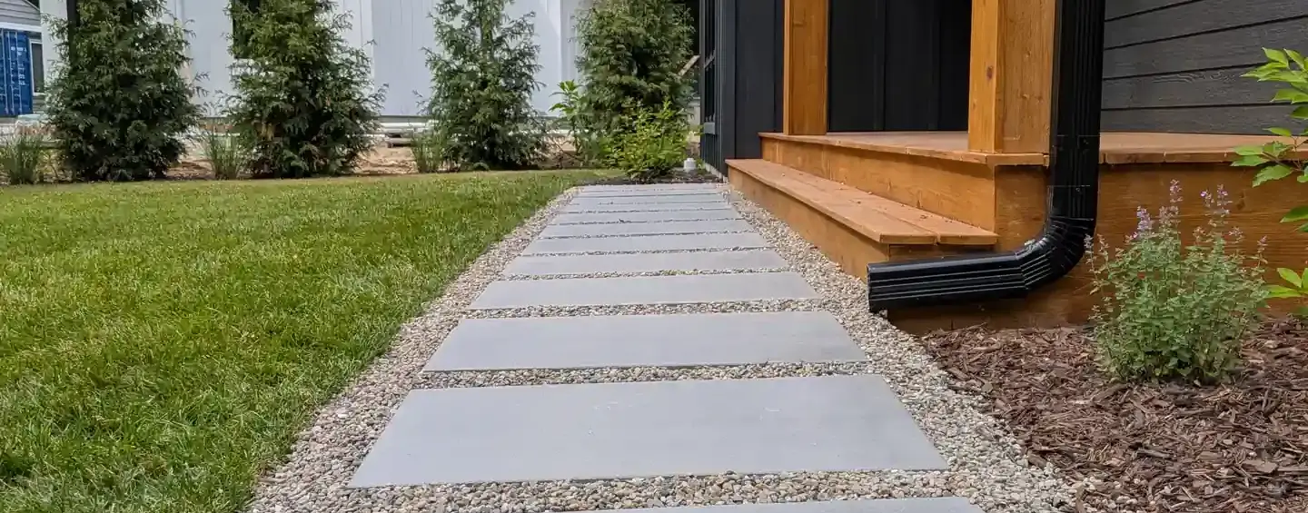 Beacon Hill Opal Blend slabs set in a pea stone walkway leading to a cedar porch in Union Pier, MI