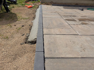 Concrete edge restraint on paver patio