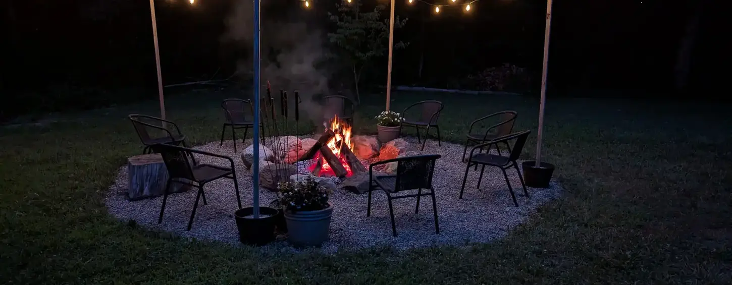 Fieldstone boulder fire pit with pea-stone seating area in Niles, MI