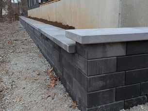 Unilock Quarry Smooth midnight charcoal retaining wall with Beacon Hill opal blend coping installed in Berrien County MI