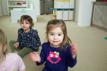 Clapping along during circle time at Blue Sky Daycare home daycare