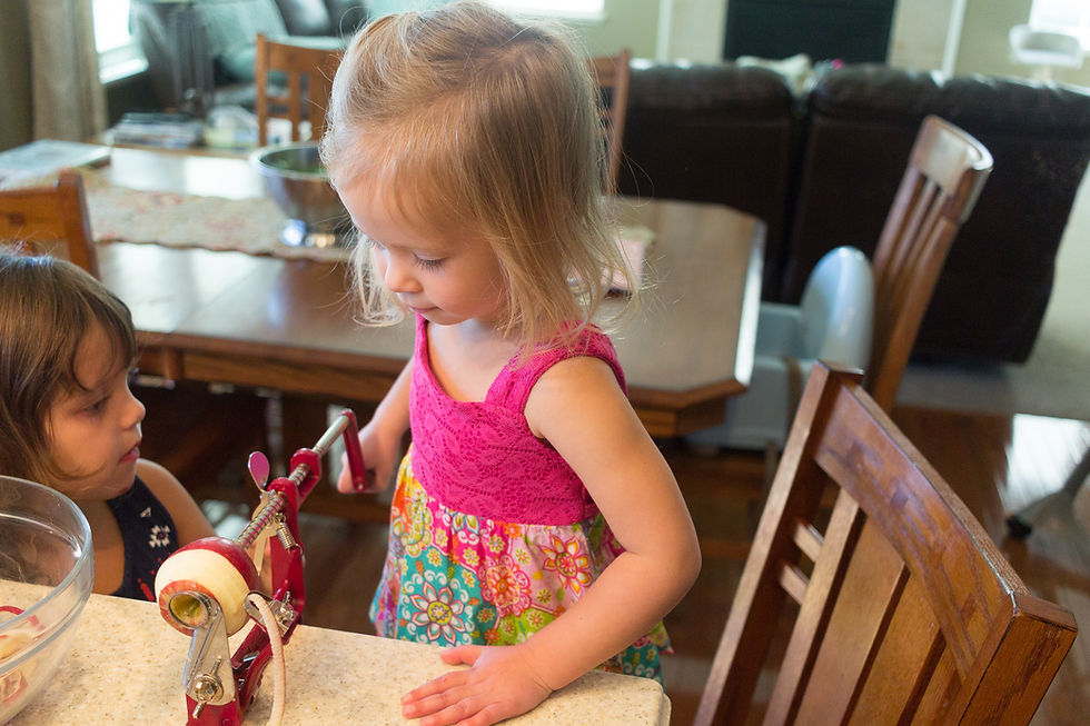 A Blue Sky Daycare child helps make applesauce from fresh-picked apples.