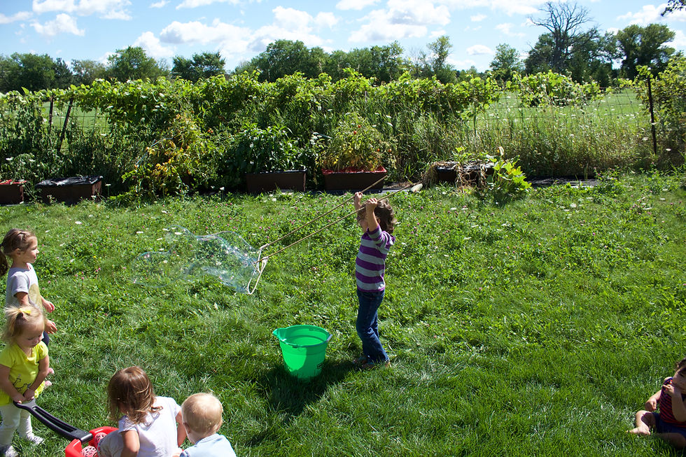 Blue Sky Daycare home daycare children exploring giant bubbles