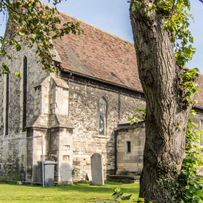 A medieval church behind a tree