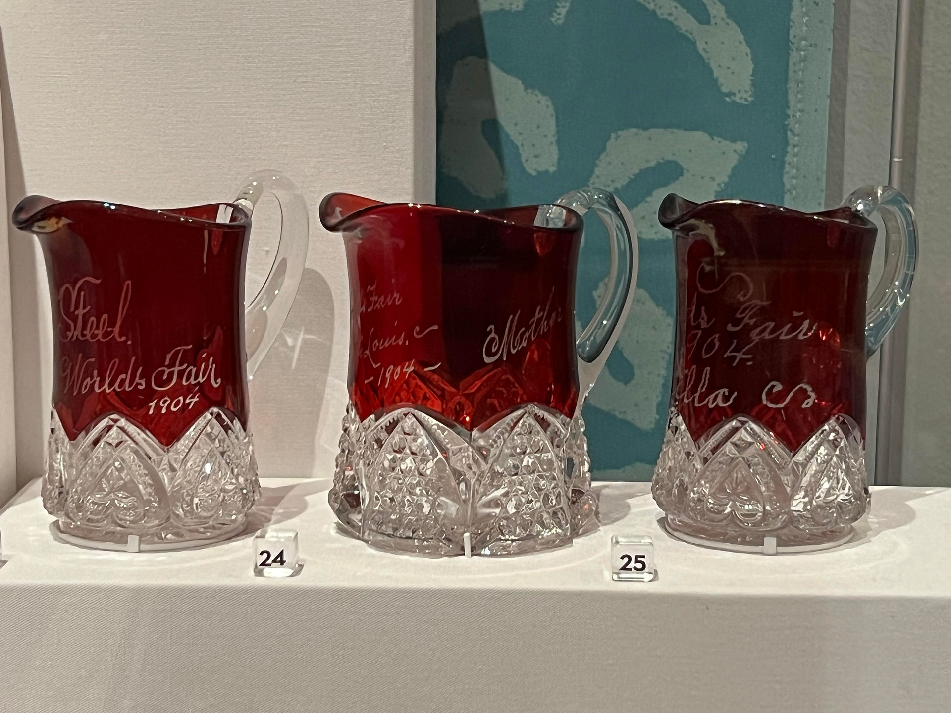 Close-up of ruby-red stained glassware souvenirs etched with World's Fair