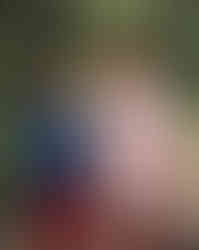 Two girls standing in a wooded area