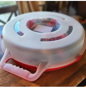 White and red plastic wreater container placed on a wooden tabletop