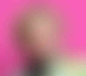 Close-up of comedian Fortune Feimster against a pink backdrop