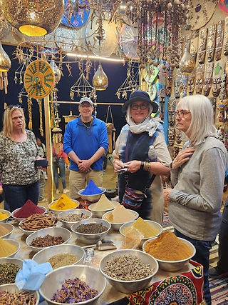 Tourists looking over a variety of spices in a shop in a Nubian village in Egypt