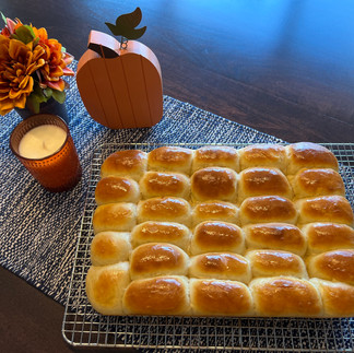 Baked dinner rolls cooling on a wire rack
