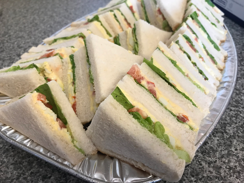 Close-up of assorted sandwich trays and sweet bites for funeral tea catering in Northern Ireland.