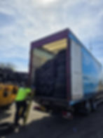 Worker loading used tires onto MWD Haulage truck