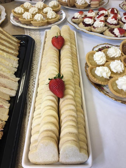 Funeral food table with fine china, sausage rolls, sandwiches and cream pastries – ready for delivery in Lisburn