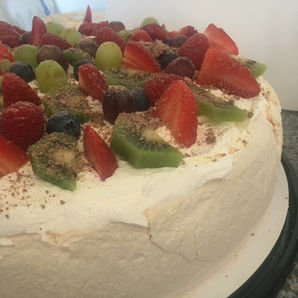 Funeral food table with fine china, sausage rolls, sandwiches and cream pastries – ready for delivery in Lisburn.