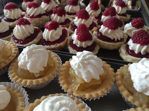 Funeral catering setup with full buffet service – traybakes, sandwiches and tea cups