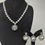 थंबनेल: Elegant Silver-Toned Necklace Set with Pink Stone Pendant and Earrings
