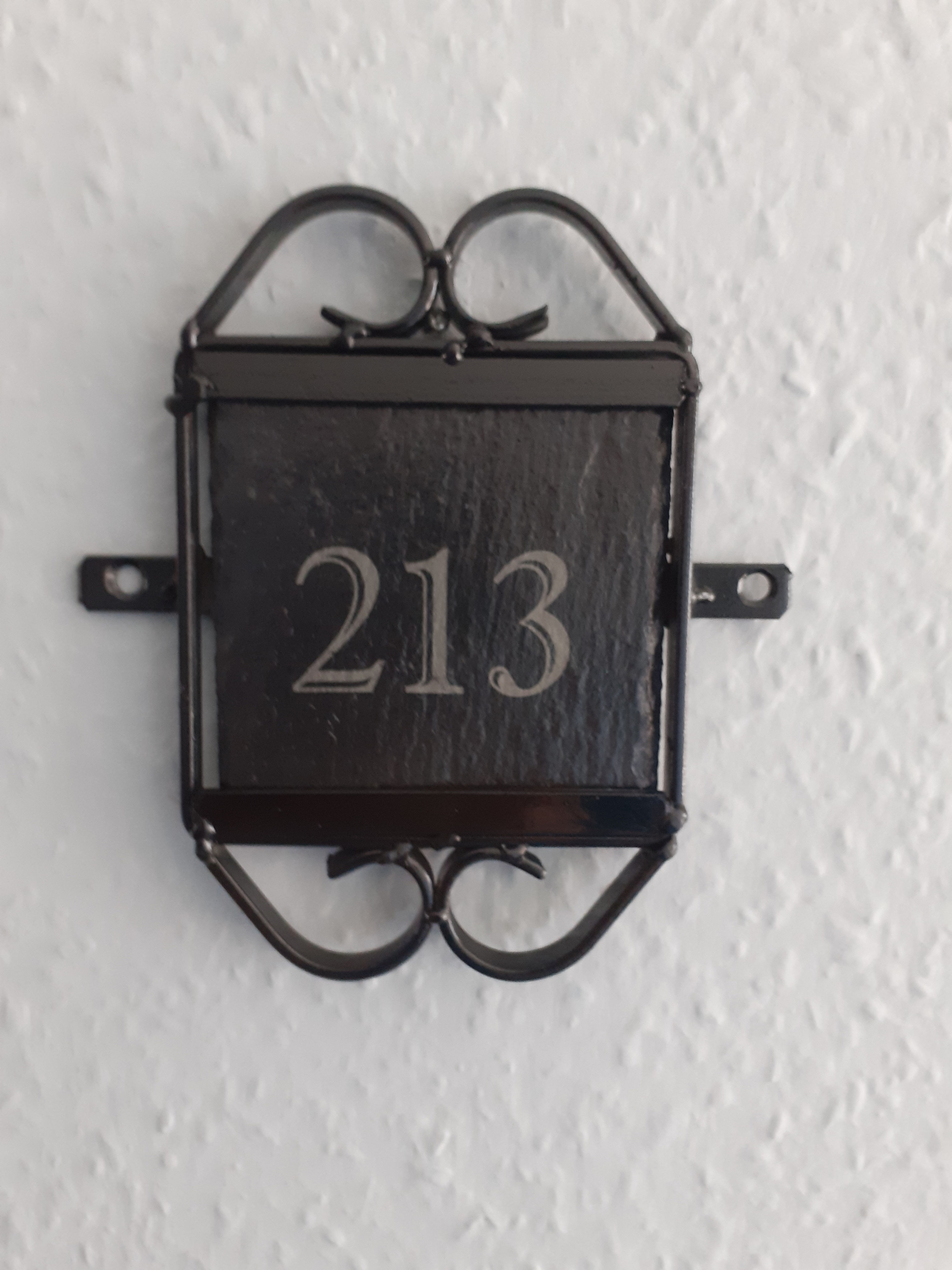 4"Engraved Door Number Slate in a Black Metal Frame to Wall Mount.