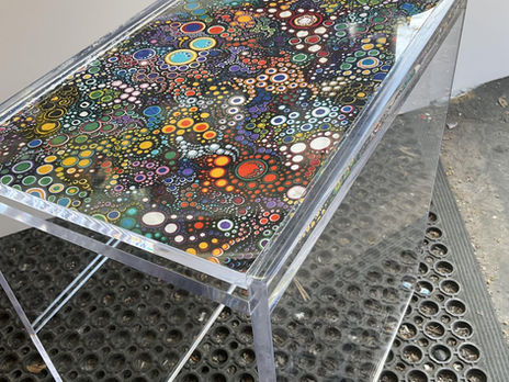 Fabric and needlepoint insert acrylic tables.