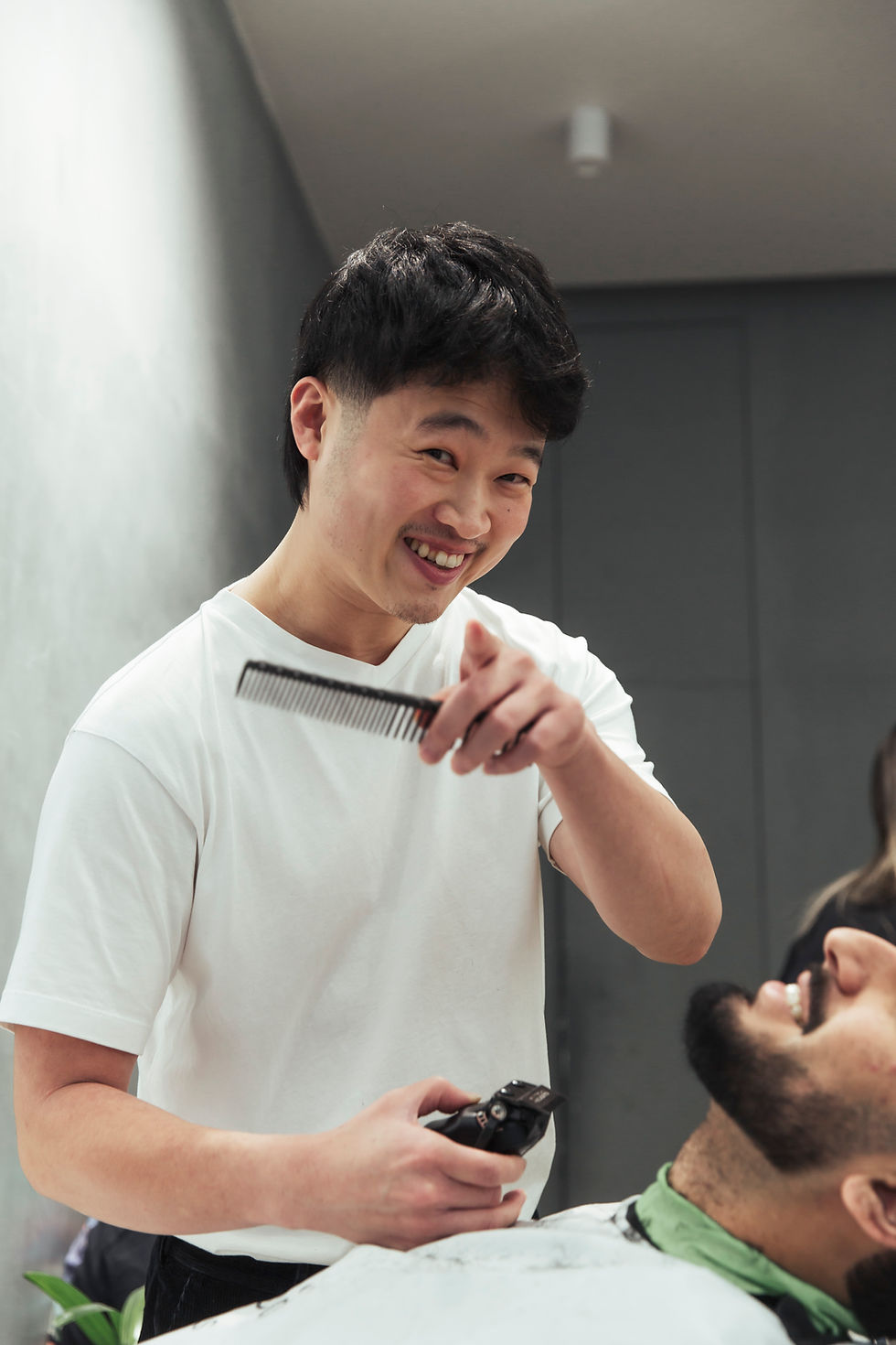 An Ikigai barber concentrating on the details of a client’s haircut