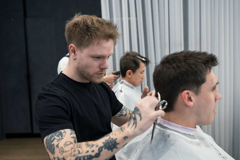 An Ikigai barber carefully shaping the hair around a client’s ear