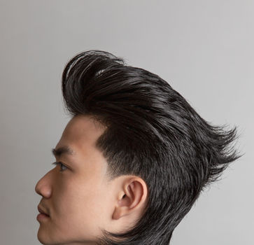 Sculpted swept-back hairstyle in side profile, created by Sam at Ikigai Barbers in Melbourne.