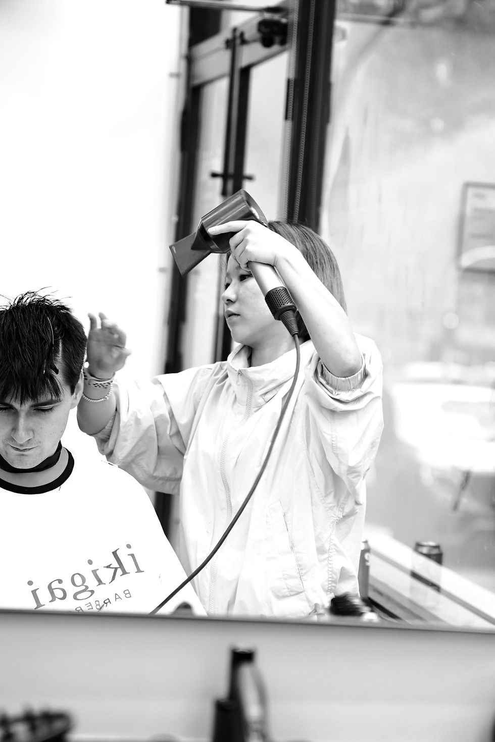 Barber styling a client's hair at Ikigai Barbers