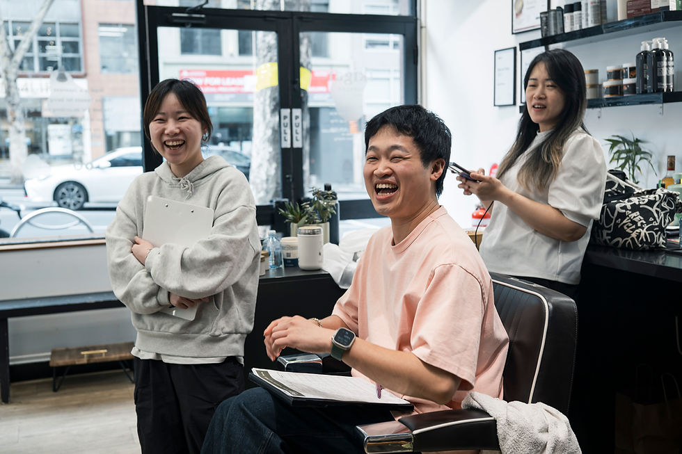 A barber and client sharing a relaxed conversation at Ikigai Barbers