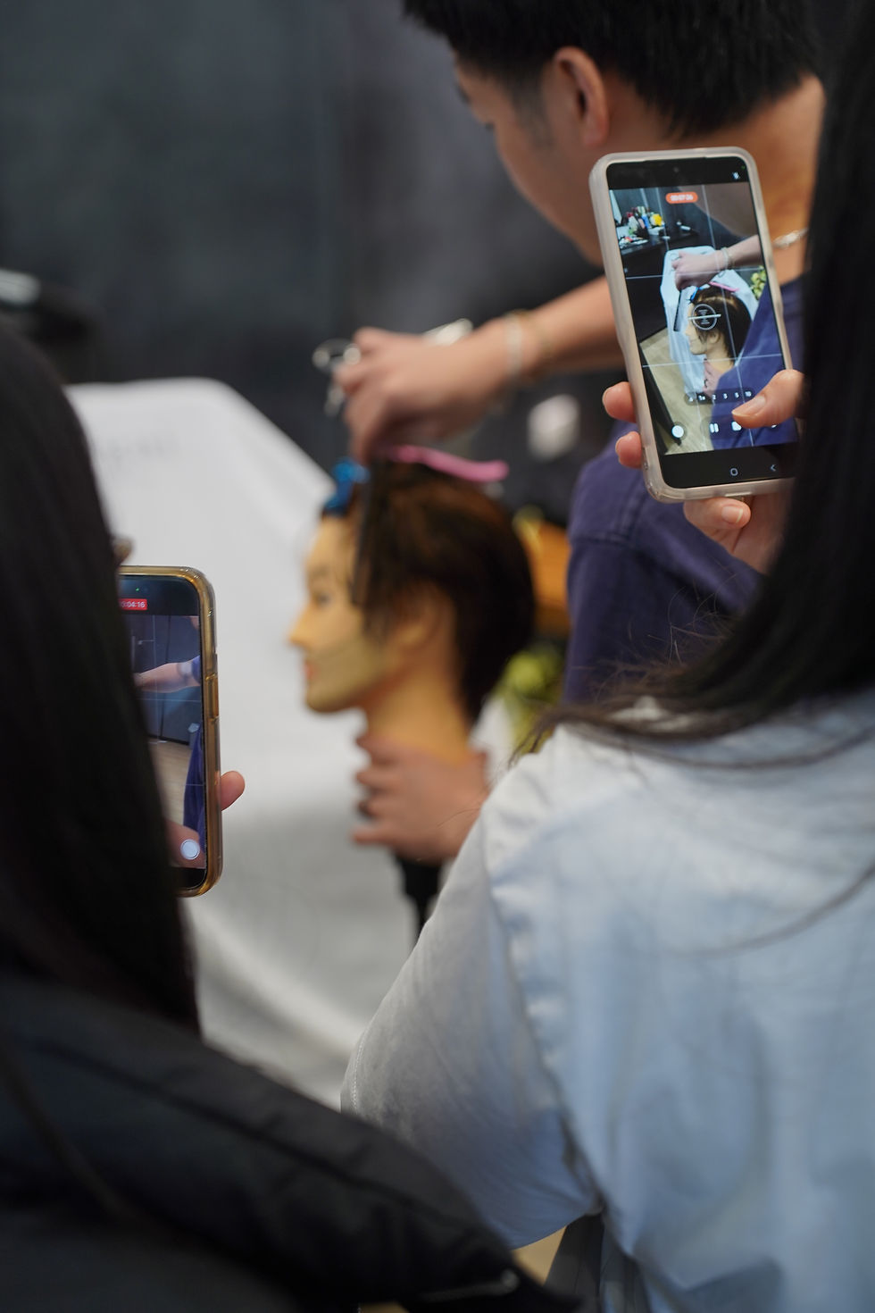 An Ikigai barber working on a client’s haircut at a barbering event