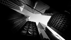 A black and white photo of tall skyscrapers viewed from below, symbolizing limitless opportunities in the digital landscape.