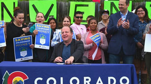 Andy Boesenecker at a bill signing event with Jared Polis in Fort Collins, Colorado