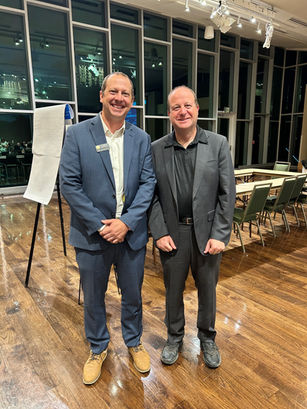 Andy Boesenecker with Jared Polis in a ballroom at Colorado State University