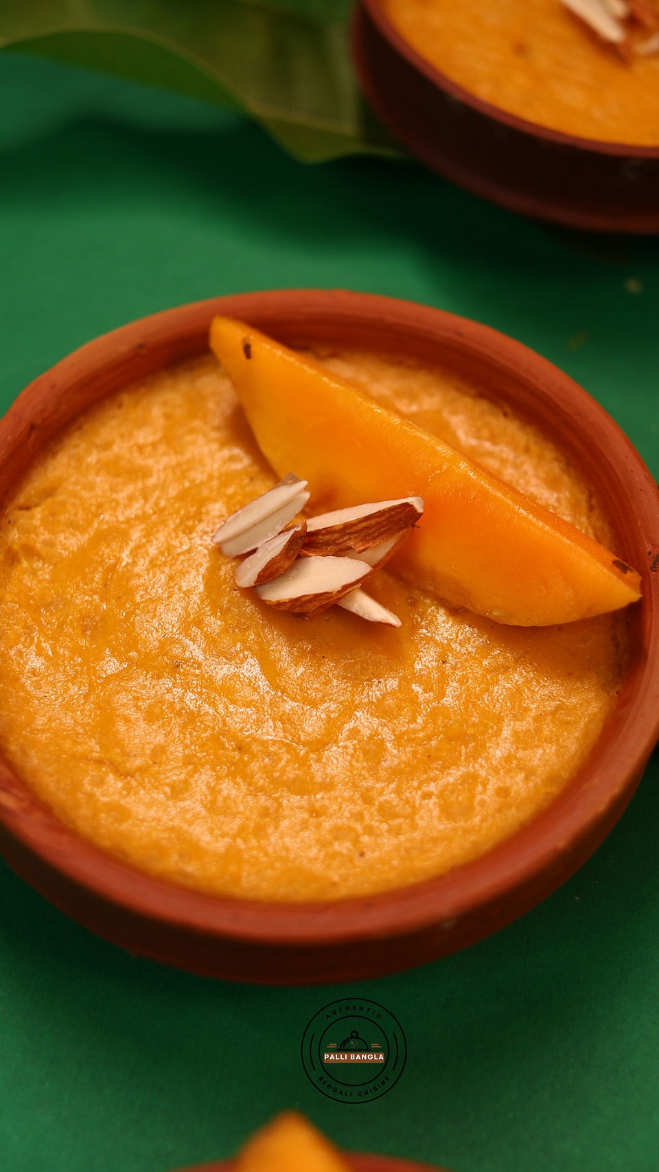 Phirni served in a clay pot with Alphonso mango slices on top