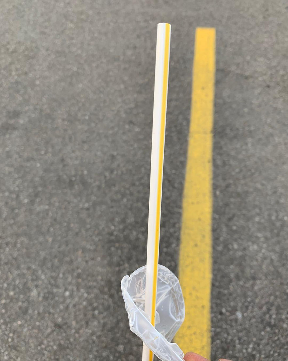 Littered plastic straw and drink lid