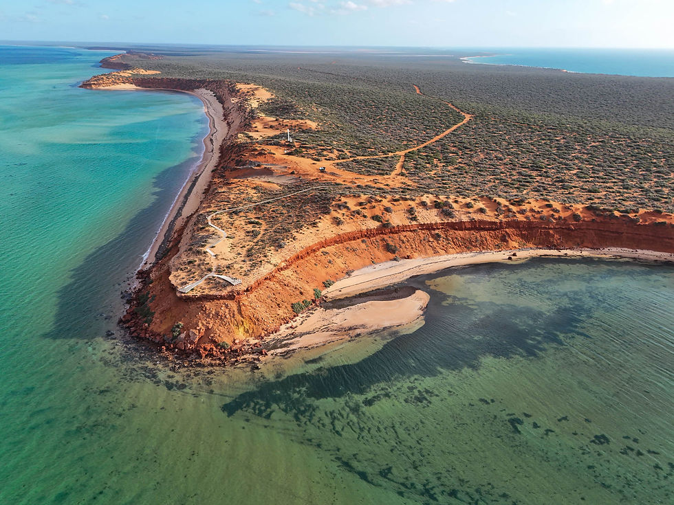 Aerial view of Cape Peron in Francois Peron National Park, showing the Skipjack Point boardwalk, dramatic red sand cliffs and turquoise waters of Shark Bay, Western Australia.