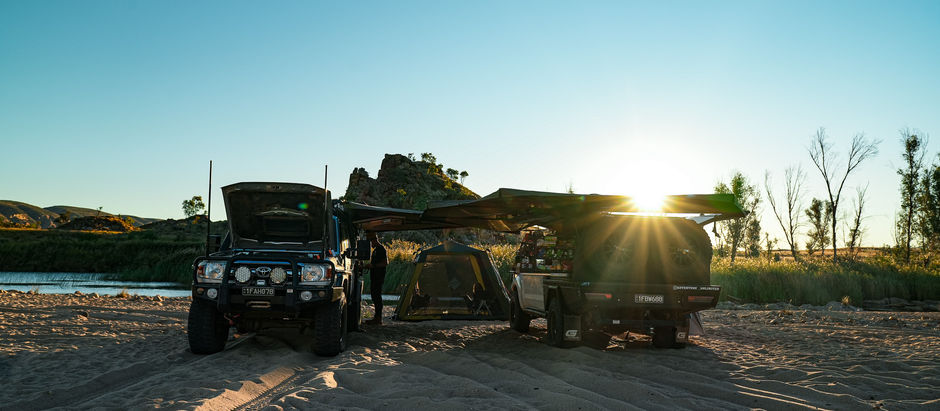 The setting sun glistens just above our camp at Finke River 2 Mile