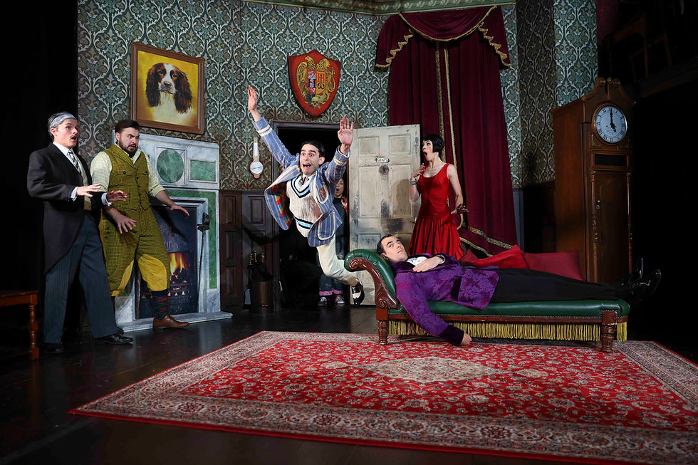 Man in striped suit leaps joyfully over a purple-clad man reclining on a chaise in a vintage room with ornate wallpaper, red carpet, and clock.